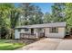 Charming renovated home with a deck, landscaped front yard, and a modern white exterior at 30 Dewey Se Ln, Marietta, GA 30060