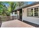 Charming front porch with a stained wood deck, black door, and white siding at 30 Dewey Se Ln, Marietta, GA 30060