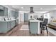 Open-concept kitchen with stainless steel appliances, a center island with bar stools, and hardwood flooring at 30 Dewey Se Ln, Marietta, GA 30060