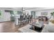 Modern kitchen with gray-blue cabinetry, a central island with seating, and an open layout to the dining area at 30 Dewey Se Ln, Marietta, GA 30060
