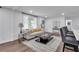 Bright living room with comfortable seating, a decorative rug, and an open connection to the kitchen area at 30 Dewey Se Ln, Marietta, GA 30060