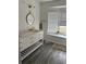 Bright bathroom featuring a double vanity with elegant marble countertops and modern fixtures at 735 Brookwood Dr, Forest Park, GA 30297