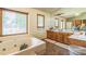 Bathroom with large jacuzzi tub, double sinks and vanity at 9959 Point View Dr, Jonesboro, GA 30238