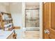 Bathroom with standing shower, wood-look tile flooring and custom wood shelves at 9959 Point View Dr, Jonesboro, GA 30238