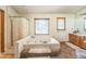 Spacious bathroom with a large jacuzzi tub and window at 9959 Point View Dr, Jonesboro, GA 30238
