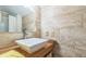 Bathroom featuring stone wall tile, floating vessel sink and chrome faucet at 9959 Point View Dr, Jonesboro, GA 30238