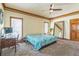 Bedroom with ceiling fan, carpeted floors and large windows with view of outside at 9959 Point View Dr, Jonesboro, GA 30238