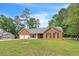 A charming brick home with an attached garage and a spacious front lawn at 9959 Point View Dr, Jonesboro, GA 30238