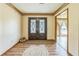 Warm foyer showcasing beautiful wood flooring and a decorative double front door at 9959 Point View Dr, Jonesboro, GA 30238