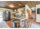 Rustic kitchen with a wood plank ceiling, granite counters, stainless steel appliances, and wooden floors at 9959 Point View Dr, Jonesboro, GA 30238