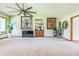 Large living room featuring a wet bar, ceiling fan, and ample natural light at 9959 Point View Dr, Jonesboro, GA 30238