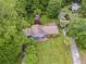 An aerial view of a house with lush surrounding greenery, a shed, and a well-maintained lawn at 385 Vineyard Nw Dr, Marietta, GA 30064