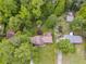 An aerial view of the house surrounded by lush trees, featuring a spacious yard and a complementing storage shed at 385 Vineyard Nw Dr, Marietta, GA 30064