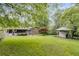 Expansive backyard featuring lush greenery, a charming shed, and a screened-in porch perfect for outdoor relaxation at 385 Vineyard Nw Dr, Marietta, GA 30064