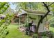 Backyard featuring a grill near an outdoor building with a moss-covered roof at 385 Vineyard Nw Dr, Marietta, GA 30064