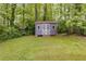 Backyard featuring a shed with gray paint, white trim, and a double door at 385 Vineyard Nw Dr, Marietta, GA 30064