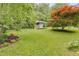 Landscaped backyard featuring a small building among lush greenery at 385 Vineyard Nw Dr, Marietta, GA 30064
