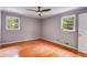 Bright bedroom with hardwood floors, neutral wall color, and two windows providing plenty of natural light at 385 Vineyard Nw Dr, Marietta, GA 30064