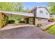 Attached carport to the home with a covered walkway and a well-manicured lawn at 385 Vineyard Nw Dr, Marietta, GA 30064