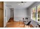 Charming dining area with a glass table, modern chairs, hardwood floors, and natural light from the window at 385 Vineyard Nw Dr, Marietta, GA 30064