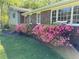 Home exterior features brick accents, blooming shrubs, and large windows at 385 Vineyard Nw Dr, Marietta, GA 30064