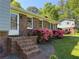 Home exterior features brick accents, blooming shrubs, a brick staircase, and a white front door at 385 Vineyard Nw Dr, Marietta, GA 30064