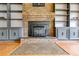 Close-up of brick fireplace with vintage grate, flanked by built-in shelves and cabinetry at 385 Vineyard Nw Dr, Marietta, GA 30064