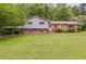 Charming two-story home with brick accents, a well-manicured lawn, and mature trees at 385 Vineyard Nw Dr, Marietta, GA 30064