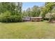 Charming two-story home with brick accents, a well-manicured lawn, and mature trees at 385 Vineyard Nw Dr, Marietta, GA 30064