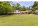 Charming two-story home with brick accents, a well-manicured lawn, and mature trees at 385 Vineyard Nw Dr, Marietta, GA 30064