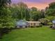 Charming two-story home with brick accents, a well-manicured lawn, and mature trees at 385 Vineyard Nw Dr, Marietta, GA 30064