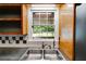 This is a kitchen view with a stainless steel sink, checkered backsplash, and a window for natural light at 385 Vineyard Nw Dr, Marietta, GA 30064