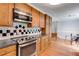 Modern kitchen with stainless steel appliances, wood cabinets, and eat-in area perfect for Gathering meals at 385 Vineyard Nw Dr, Marietta, GA 30064