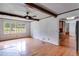 Spacious living room showcasing hardwood floors, a fireplace with wood beam accents, and natural light at 385 Vineyard Nw Dr, Marietta, GA 30064