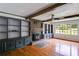 Bright living room boasts hardwood floors, a brick fireplace, and built-in shelving for ample storage at 385 Vineyard Nw Dr, Marietta, GA 30064