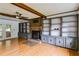 The living room features hardwood floors, built-in bookshelves, a fan, and a brick fireplace at 385 Vineyard Nw Dr, Marietta, GA 30064