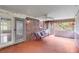 Relaxing screened porch with brick flooring, swing, fan, and outdoor seating perfect for entertaining guests at 385 Vineyard Nw Dr, Marietta, GA 30064