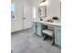 Updated bathroom with blue vanity, white quartz countertops, modern fixtures, and gray tile floor at 1075 Litchfield Sw Way, Marietta, GA 30060