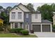 Charming two-story home featuring a two-car garage and manicured front yard at 1075 Litchfield Sw Way, Marietta, GA 30060