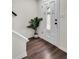 Entryway with wood-look floors, a white front door with decorative glass, and a potted palm at 1075 Litchfield Sw Way, Marietta, GA 30060