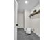 Convenient laundry room with tile floor, shelving, and ample storage space at 1075 Litchfield Sw Way, Marietta, GA 30060