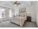 Bright main bedroom features tray ceiling, ceiling fan, carpet, and ensuite bathroom at 1075 Litchfield Sw Way, Marietta, GA 30060