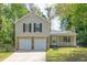 Charming two-story home with a covered porch, a two-car garage, and a well-manicured front lawn at 1147 Williamsburg Ln, Norcross, GA 30093