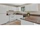 Well-equipped kitchen with white cabinetry, stone countertops, and modern appliances at 1147 Williamsburg Ln, Norcross, GA 30093