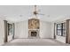 Spacious living room featuring a stone fireplace, vaulted ceiling, and ample natural light at 1147 Williamsburg Ln, Norcross, GA 30093