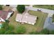 Aerial view of house showing large backyard, patio, and mature trees in a neighborhood setting at 205 Summer Walk Dr, Covington, GA 30016