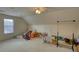 Attic with a ceiling fan and dormer window provides versatile storage or living space with natural light and ventilation at 205 Summer Walk Dr, Covington, GA 30016