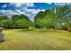 Lush backyard featuring mature trees, a well-kept lawn, and ample space for outdoor enjoyment and recreation at 205 Summer Walk Dr, Covington, GA 30016