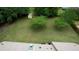 Aerial view of a large, green backyard with mature trees and a small storage shed at 205 Summer Walk Dr, Covington, GA 30016