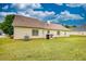 Expansive backyard with lush green grass, a small patio, and a well-maintained lawn, perfect for outdoor activities at 205 Summer Walk Dr, Covington, GA 30016